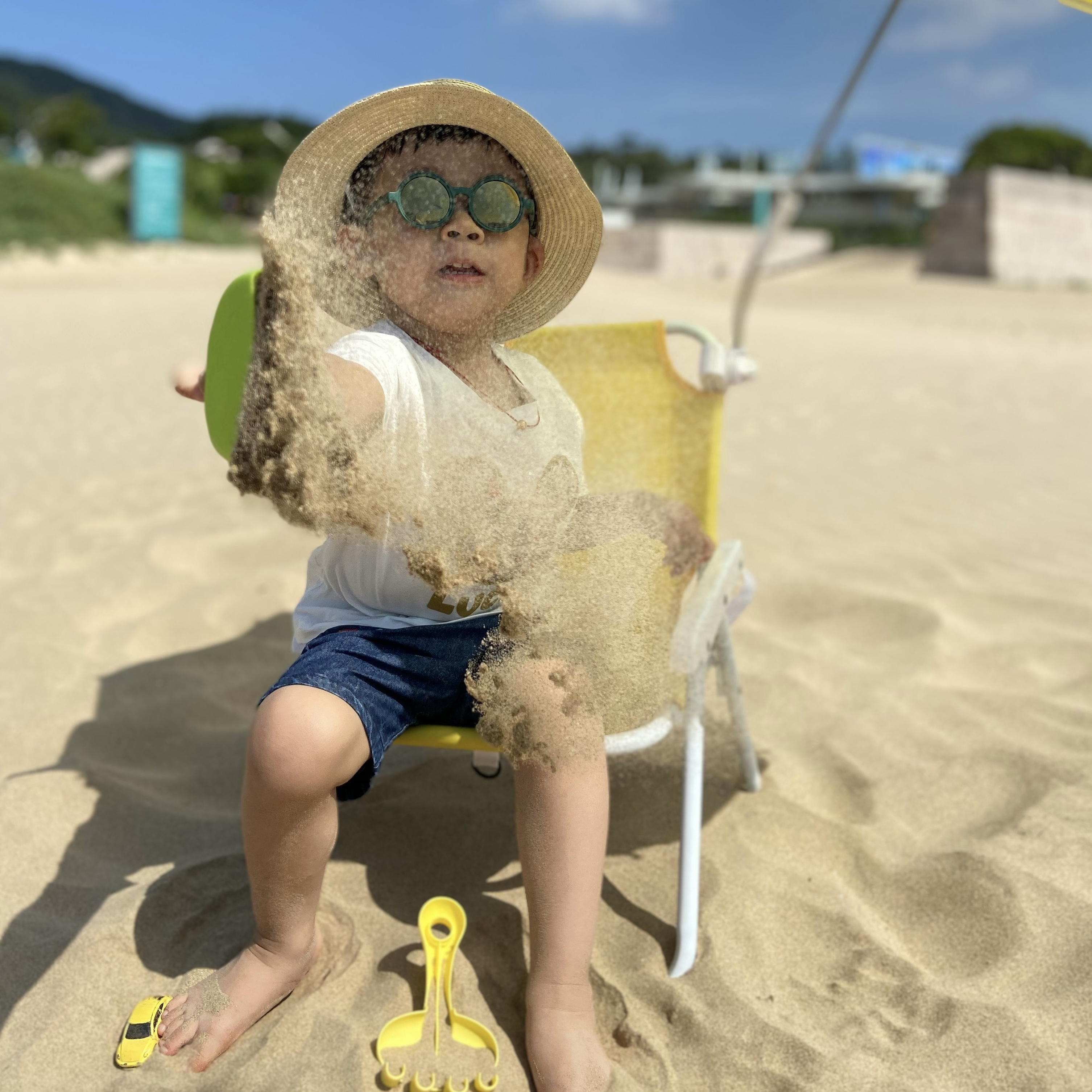 A photo of a baby boy on the beach